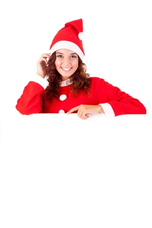Beautiful smiling young christmas woman leaning on blank signの写真素材