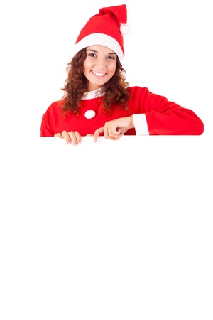 Beautiful smiling young christmas woman leaning on blank signの写真素材