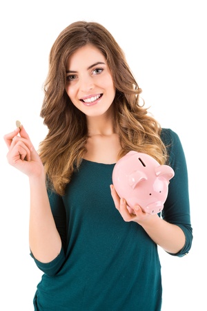 Casual woman looking to save money in a piggy bankの写真素材