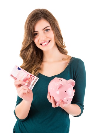 Casual woman looking to save money in a piggy bankの写真素材