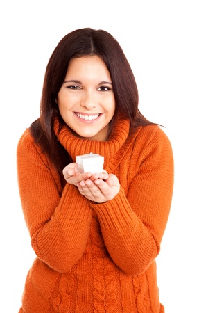 Beautiful woman holding a gift over white backgroundの写真素材