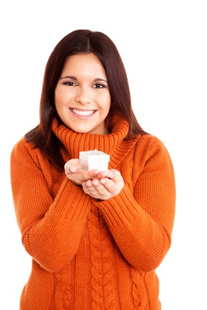 Beautiful woman holding a gift over white backgroundの写真素材