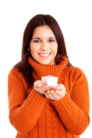Beautiful woman holding a gift over white backgroundの写真素材