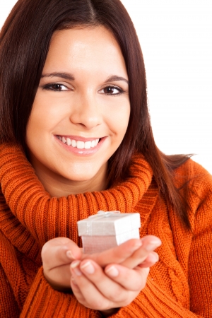 Beautiful woman holding a gift over white backgroundの写真素材