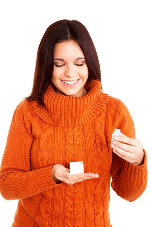 Beautiful woman holding a gift over white backgroundの写真素材