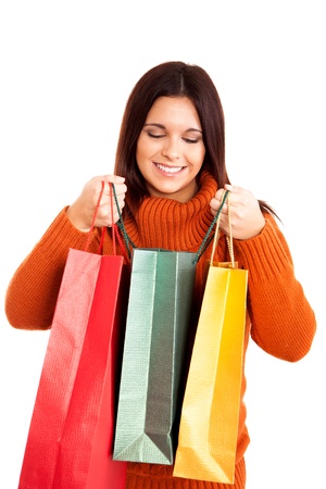 beautiful woman holding shopping bags over white backgroundの写真素材