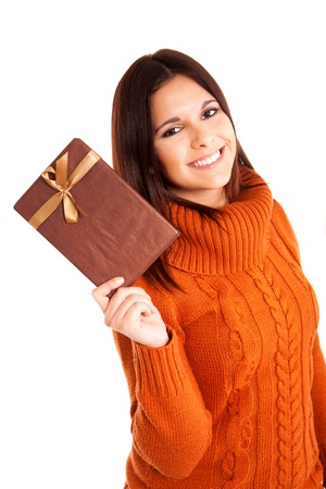 Beautiful woman holding a gift over white backgroundの写真素材