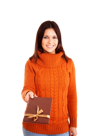 Beautiful woman holding a gift over white backgroundの写真素材