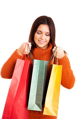beautiful woman holding shopping bags over white backgroundの写真素材
