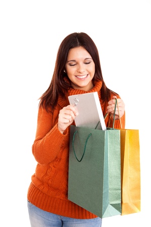 beautiful woman holding shopping bags over white backgroundの写真素材