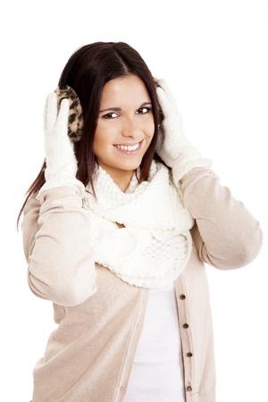 Beautiful woman wearing winter clothes over white backgroundの写真素材