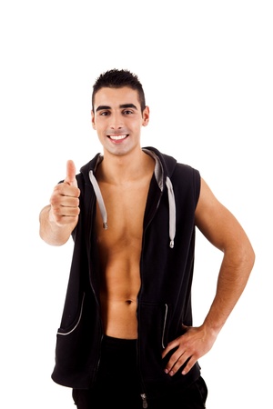 Beautiful fitness instructor doing thumbs up over whitebackgoundの写真素材