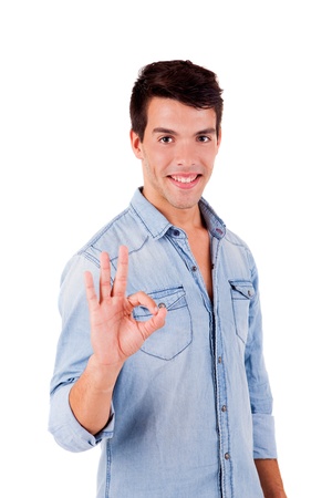 Beautiful man doing ok sign over white backgroundの写真素材