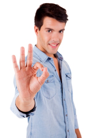 Beautiful man doing ok sign over white backgroundの写真素材