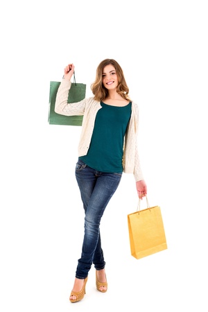 Beautiful woman holding shopping bags over white backgroungの写真素材