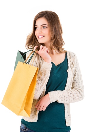 Beautiful woman holding shopping bags over white backgroungの写真素材