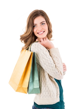 Beautiful woman holding shopping bags over white backgroungの写真素材