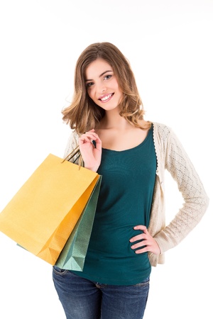 Beautiful woman holding shopping bags over white backgroungの写真素材