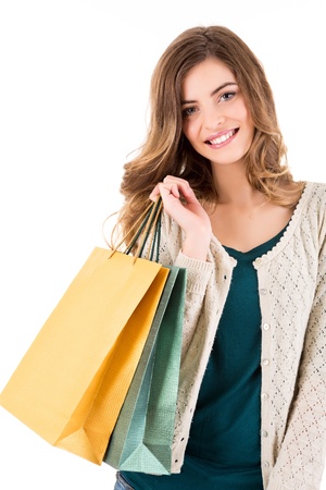 Beautiful woman holding shopping bags over white backgroungの写真素材