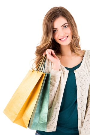 Beautiful woman holding shopping bags over white backgroungの写真素材