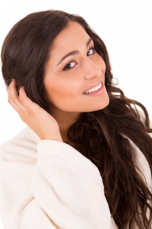 Beautiful woman enjoying with long strong brown hair isolated on white backgroundの写真素材