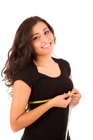 Beautiful slim woman measuring her body with a measuring tapeの写真素材