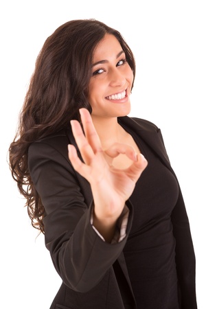 Business woman with an ok sign - isolated over a white backgroundの写真素材