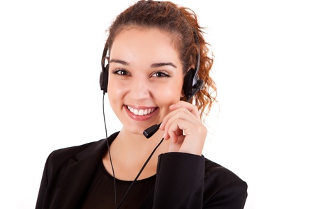 Portrait of a happy young call center employee smiling with a headset over whiteの写真素材