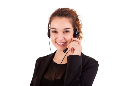 Portrait of a happy young call center employee smiling with a headset over whiteの写真素材