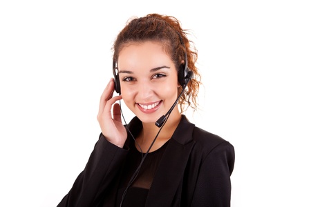 Portrait of a happy young call center employee smiling with a headset over whiteの写真素材