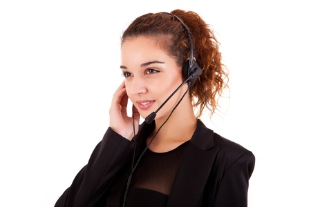 Portrait of a happy young call center employee smiling with a headset over whiteの写真素材
