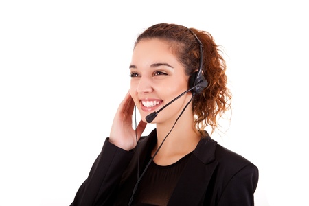Portrait of a happy young call center employee smiling with a headset over whiteの写真素材