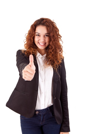 Smiling woman giving thumbs up over white backgroundの写真素材