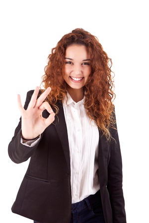Smiling woman doing the OK sign over white backgroundの写真素材