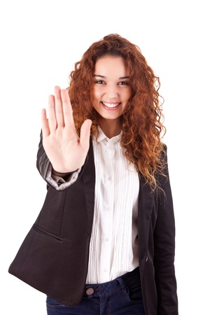 Smiling woman doing STOP sign over white backgroundの写真素材