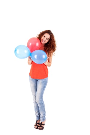 Happy beautiful woman holding balloons over white backgroundの写真素材
