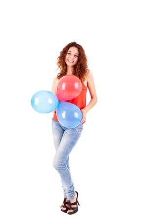 Happy beautiful woman holding balloons over white backgroundの写真素材