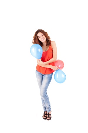 Happy beautiful woman holding balloons over white backgroundの写真素材