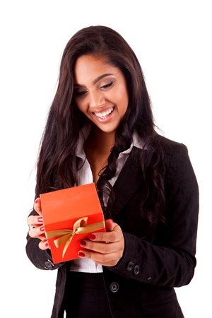 Beautiful mix race woman holding a gift over white backgroundの写真素材