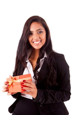 Beautiful mix race woman holding a gift over white backgroundの写真素材