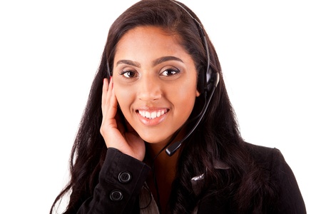 Portrait of a happy young mix race call center employee smiling with a headset over whiteの写真素材