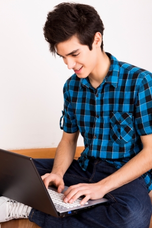 Young man working on computer laptop at homeの写真素材
