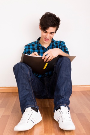 Young man studying at homeの写真素材
