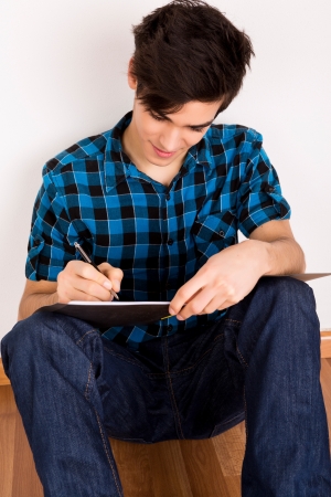 Young man studying at homeの写真素材