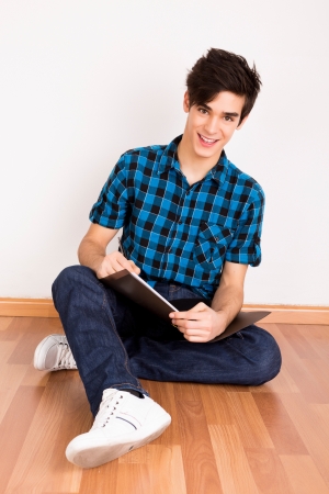 Young man studying at homeの写真素材