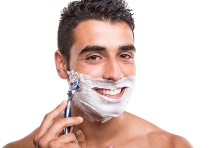 Man shaving his face over white backgroundの写真素材