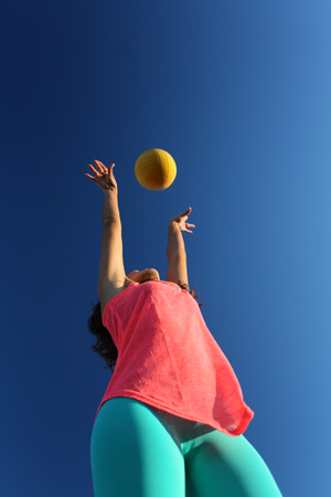 Woman playing with a ball in the city parkの写真素材