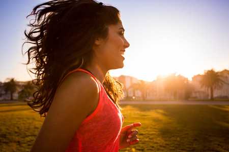Woman running in the city parkの写真素材