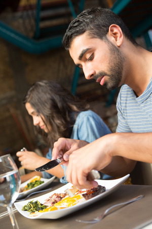 Couple having lunch at rustic gourmet restaurantの写真素材