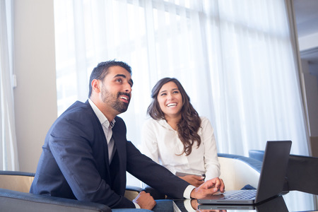 Young business couple meeting with tech devicesの写真素材